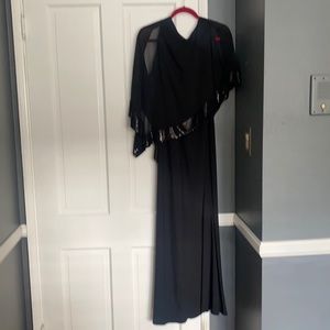 Beautiful black dress with sequins and cut outs on shoulders. New with tags.